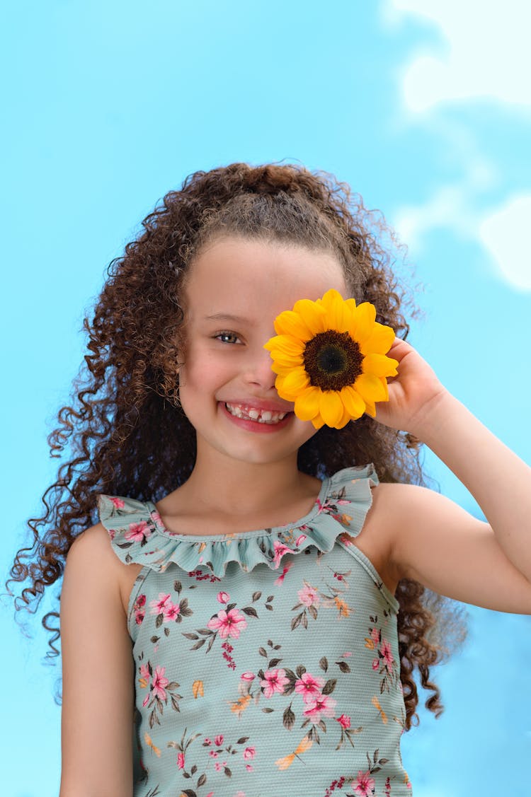 A Girl Holding A Sunflower