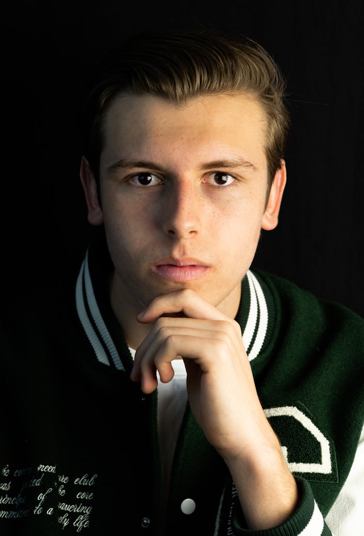 A Man Wearing A Varsity Jacket 