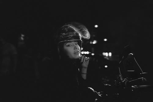 Black and White Photo of Woman Wearing Helmet