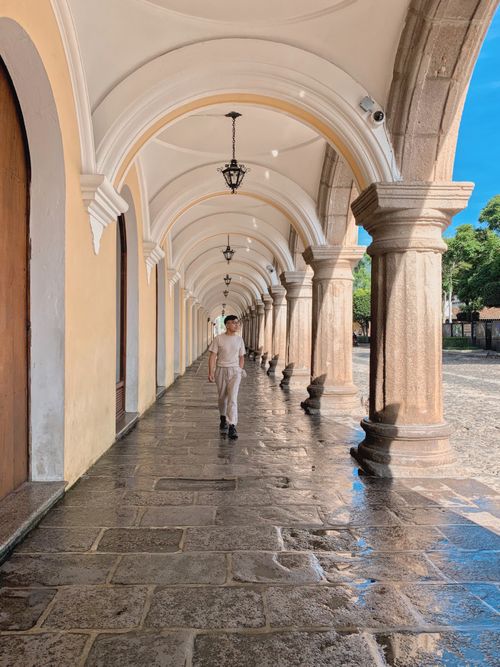 Free A person walking through the colonial archways in Antigua, Guatemala. Stock Photo