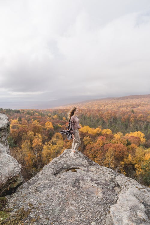 A Woman Standing on Gray Rock