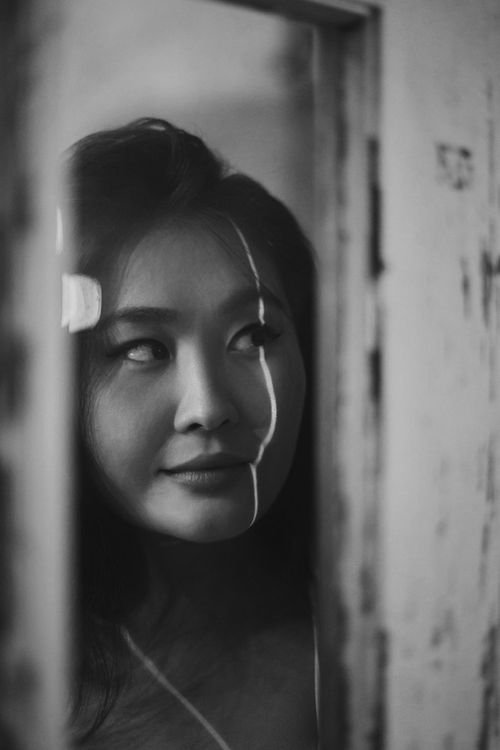 Free Black and white portrait of an Asian woman with striking light and shadow play. Stock Photo