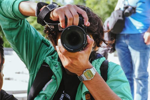 Close Up Photo of a Person Taking Photo with a Camera