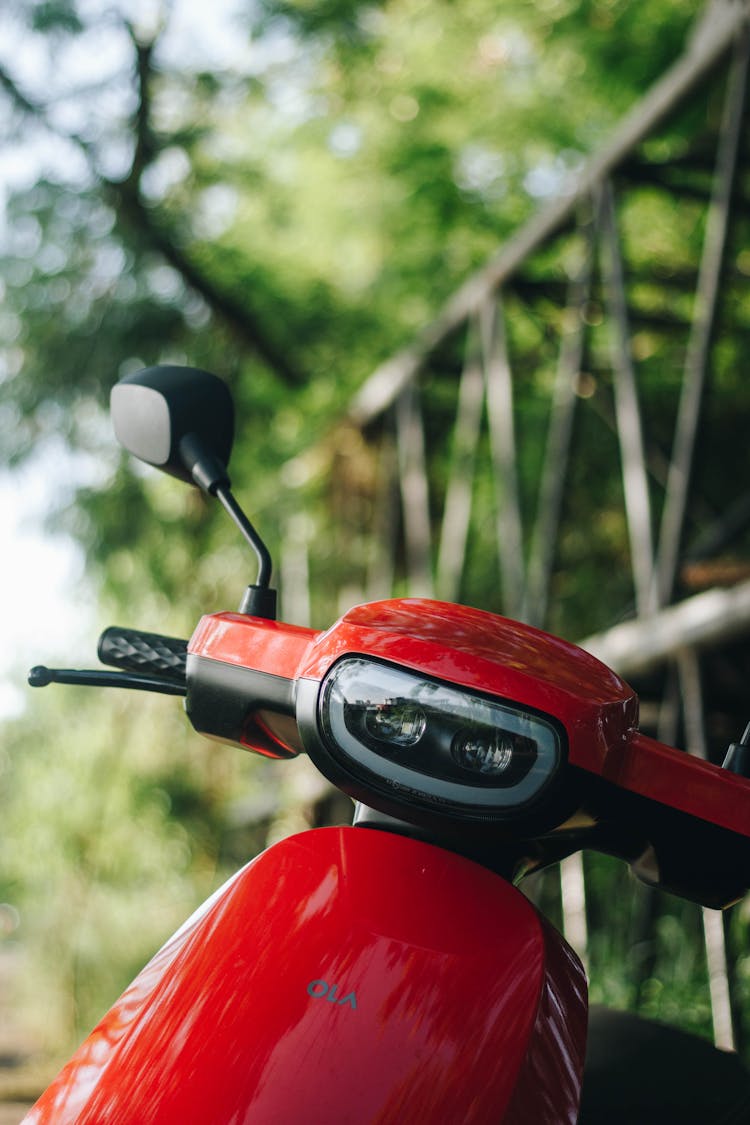 Headlights Of A Clean Red Motor Scooter