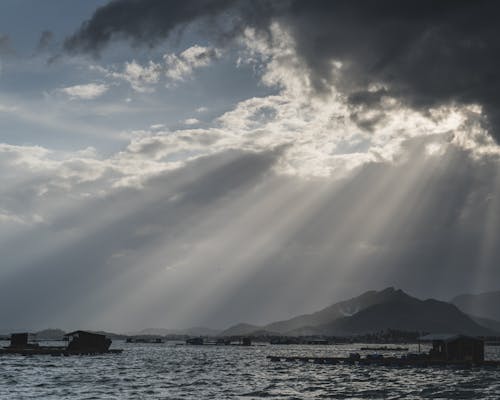 Sunbeams over Village on Sea Coast