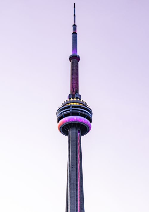 Free Stunning view of CN Tower illuminated at dusk, showcasing vibrant lighting against a clear sky in Toronto, Canada. Stock Photo