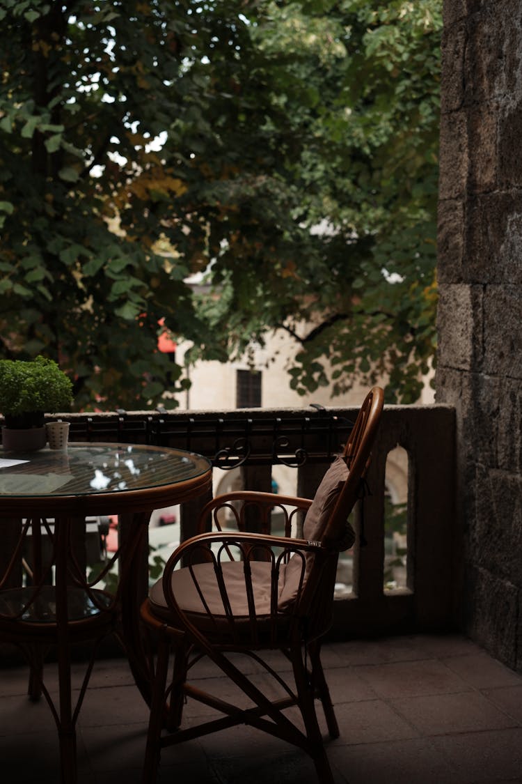 Wooden Table And Armchair On Balcony