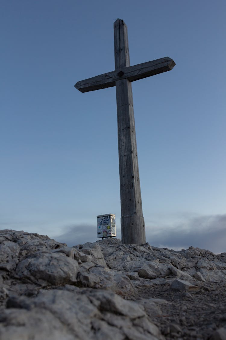 Wooden Cross On Rocky Hilltop