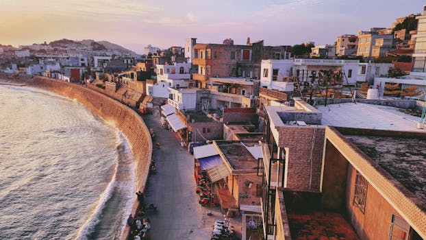 A scenic view of the coastal town in Zhangzhou City, showcasing the townscape against the sea at dusk.