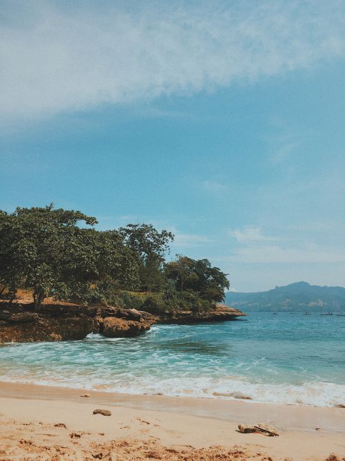 Free Discover the serene beauty of Tulungagung's coastline with clear waters and lush greenery. Stock Photo