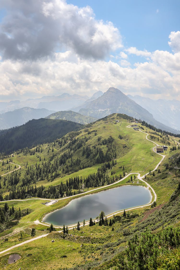 White Clouds Above Mountains And A Lake