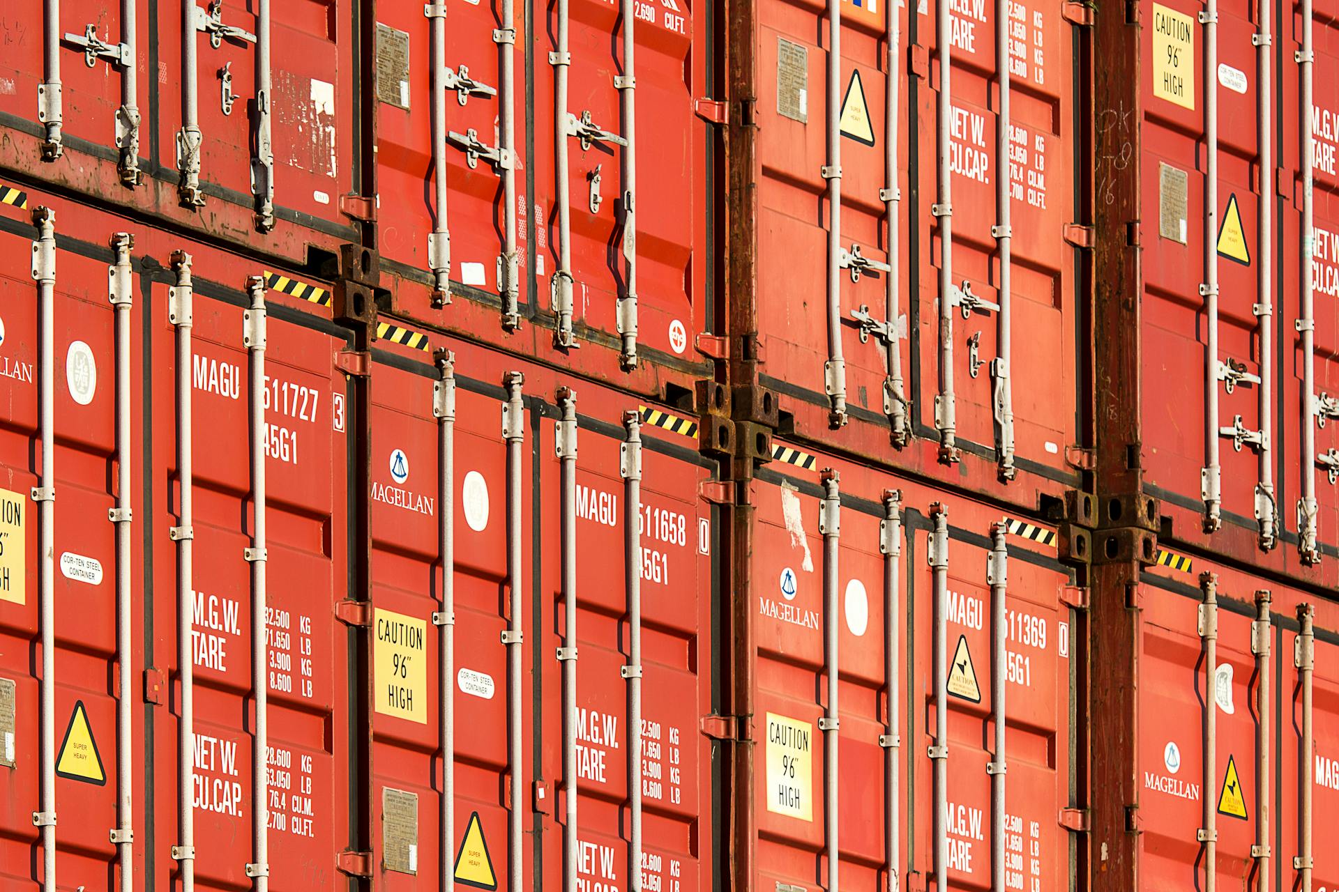 Close-up of stacked red shipping containers used for logistics and global trade.