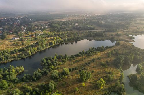 Free A breathtaking aerial view of a rural landscape with tranquil lakes and abundant greenery. Stock Photo