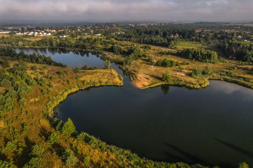 Free A stunning aerial shot of lakes surrounded by lush greenery in a rural area. Stock Photo