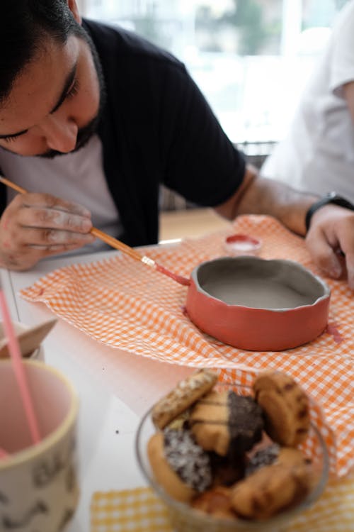 Man Painting a Clay Bowl