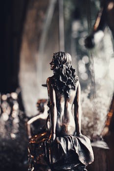 Elegant bronze statue captured with soft lighting, creating a warm and artistic atmosphere.