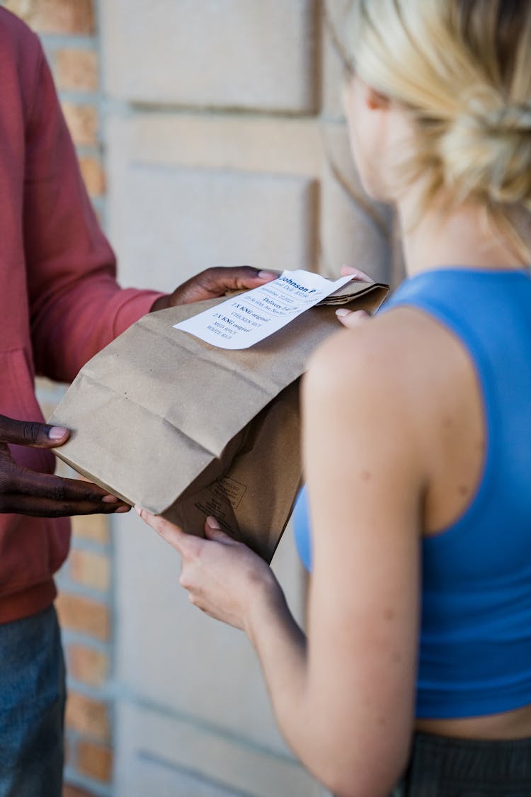 Recipient Receiving Food Delivery In Paper Bag 