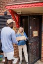Woman with Cardboard Box in Door
