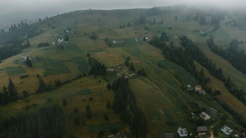 Free Foggy aerial view of rural landscape with scattered houses and greenery in Yablunytsya, Ukraine. Stock Photo