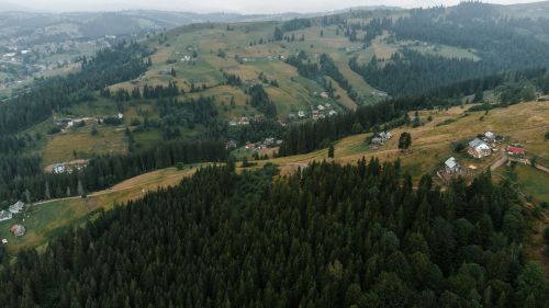 Free Scenic aerial view of Yablunytsya village in Ukraine with lush green hills and conifer forests. Stock Photo