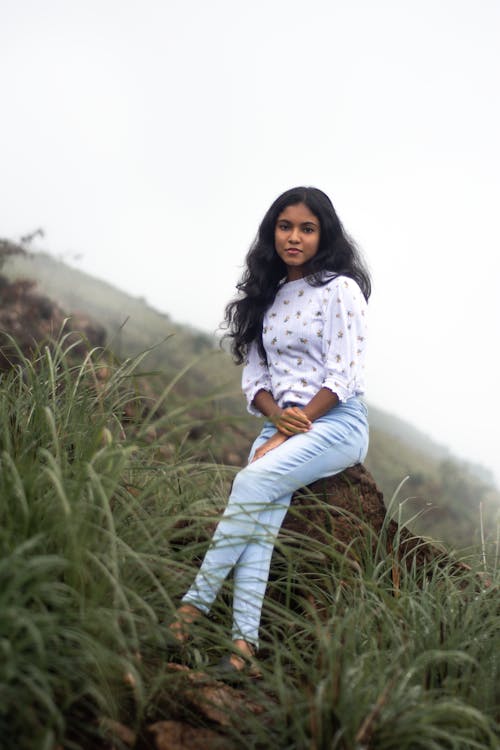 Woman in White Long Sleeve Shirt and Jeans