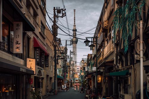 Free Vibrant urban street scene in Shinjuku City, Tokyo with a view of Tokyo Skytree. Stock Photo