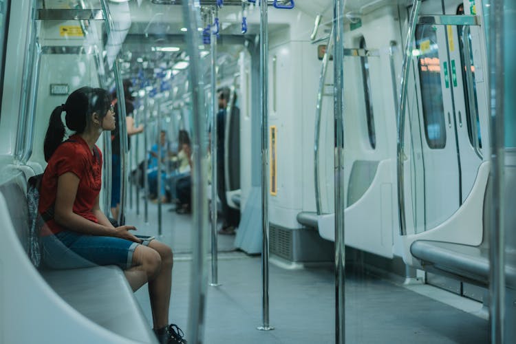 A Woman Sitting Inside The Train