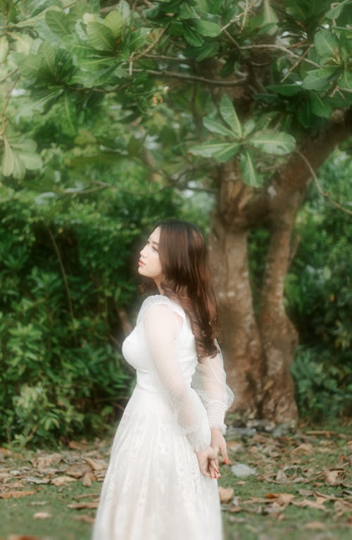 Free Woman in White Dress Standing Near Tree Stock Photo