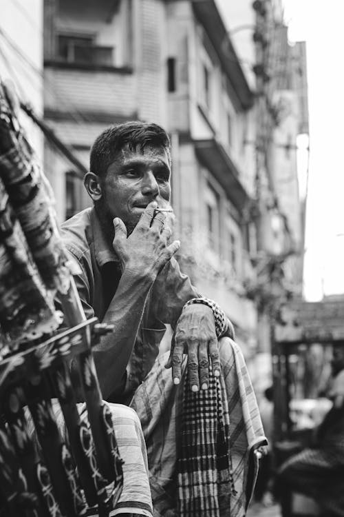 Grayscale Photo of Man Smoking Cigarette