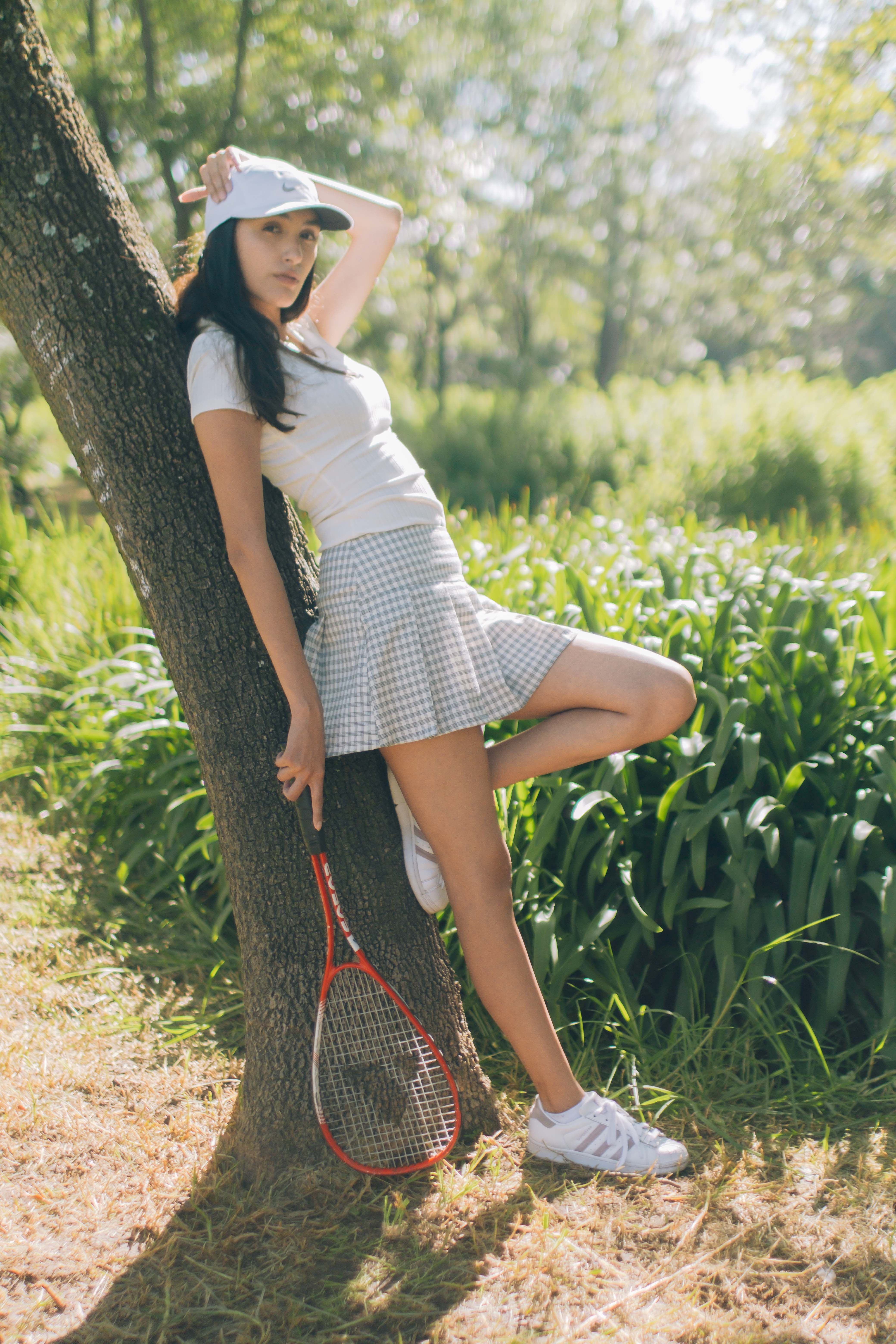 Woman Standing Beside Tree Trunk · Free Stock Photo