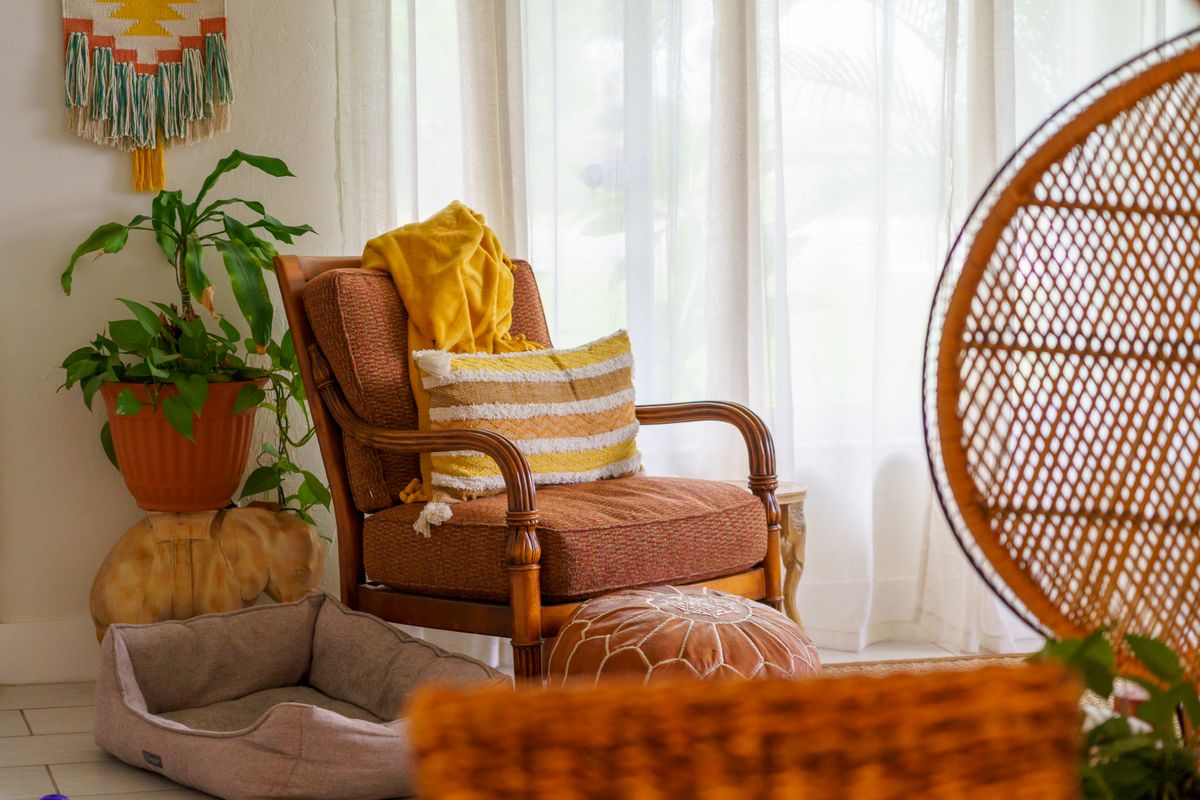 Wooden armchair with a yellow throw blanket draped over it