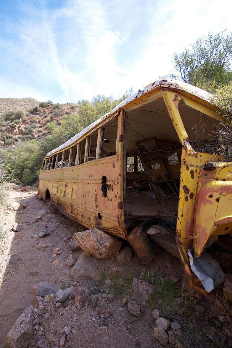 Abandoned Yellow Bus On Gray Dirt Road