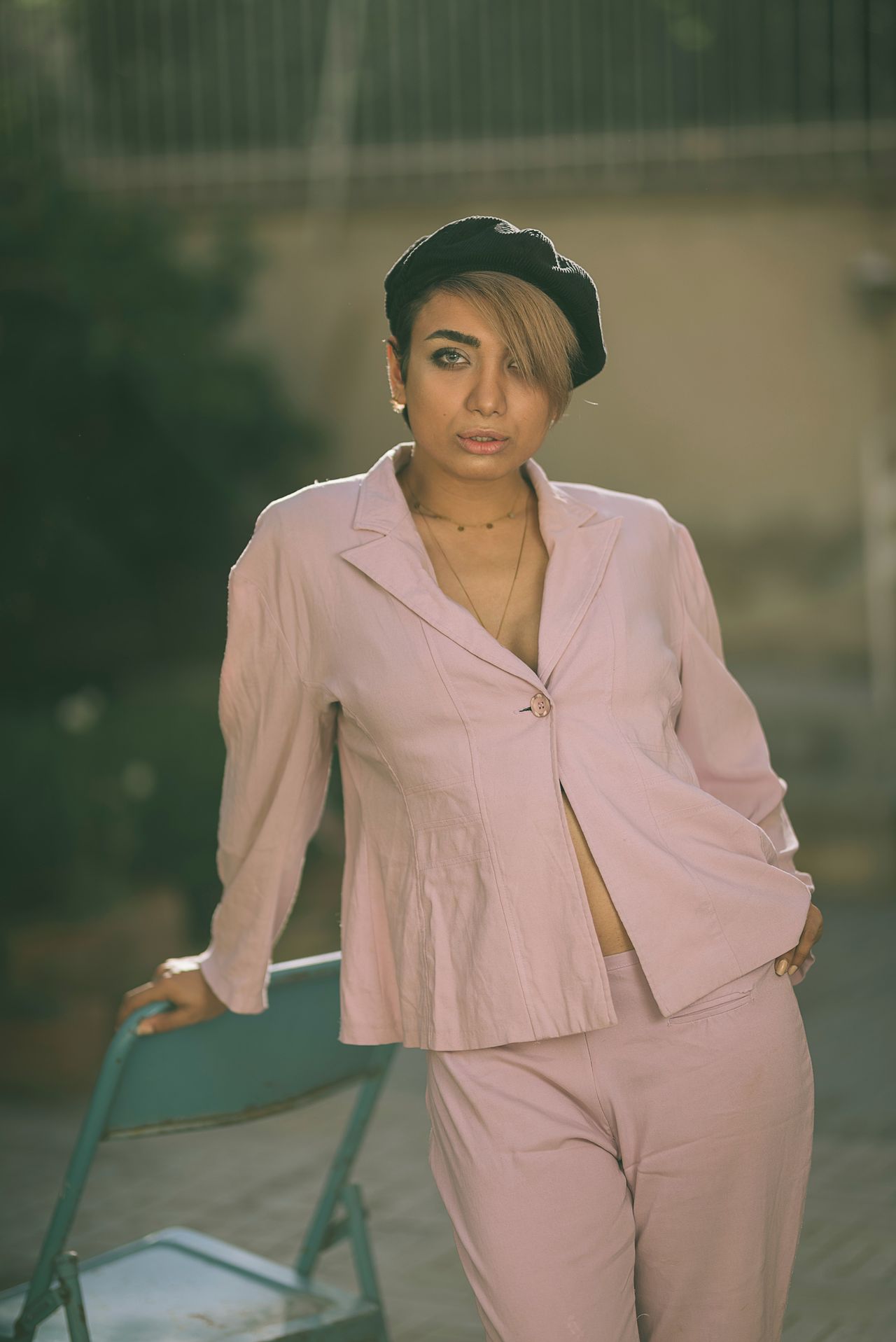 Woman in a dusty pink suit and beret in soft muted tones