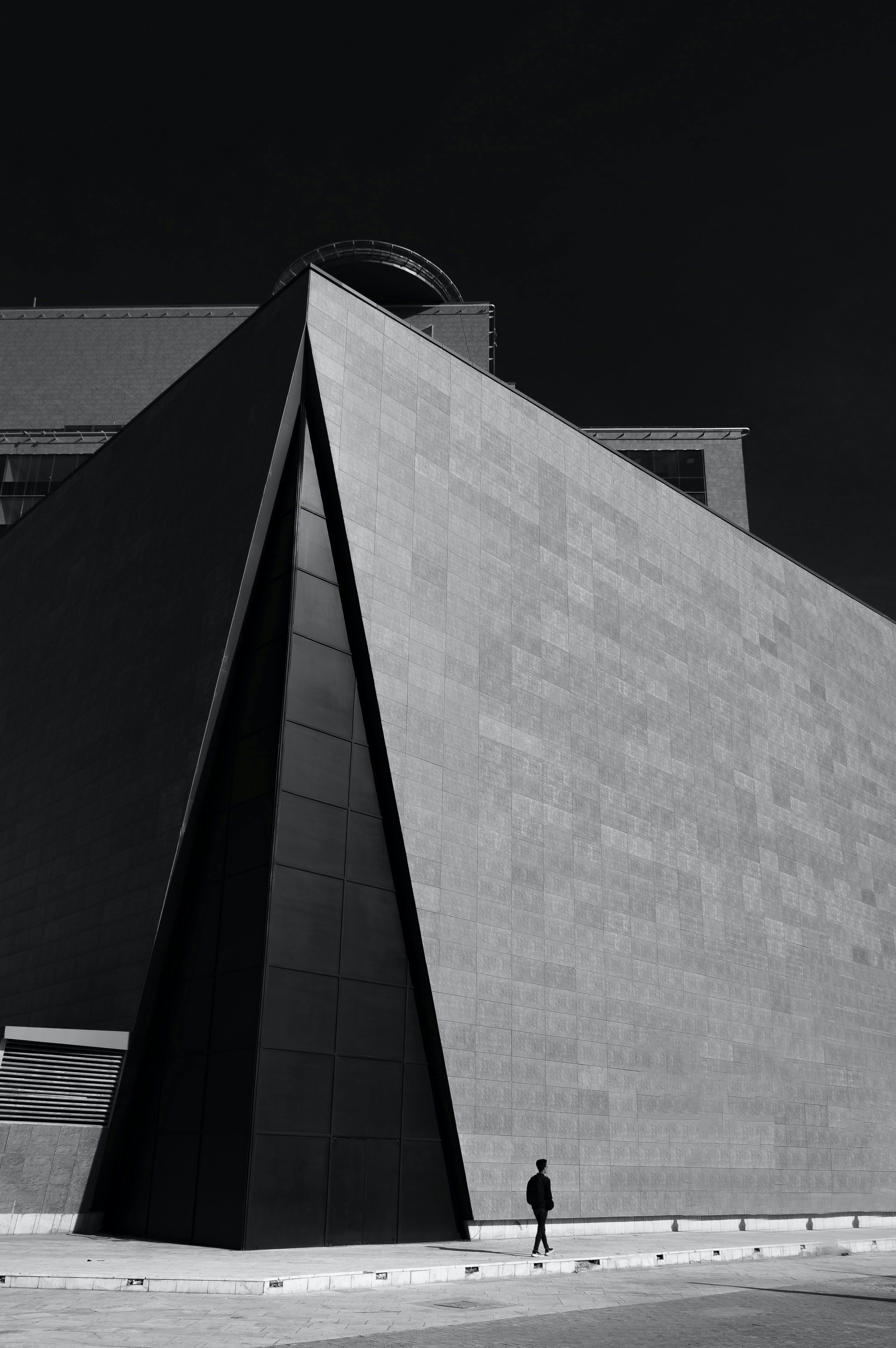 A striking black and white photo of a modern building with strong geometric shapes.