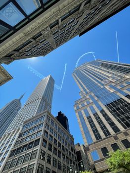 A stunning low-angle view of New York City's iconic skyscrapers against a clear blue sky.