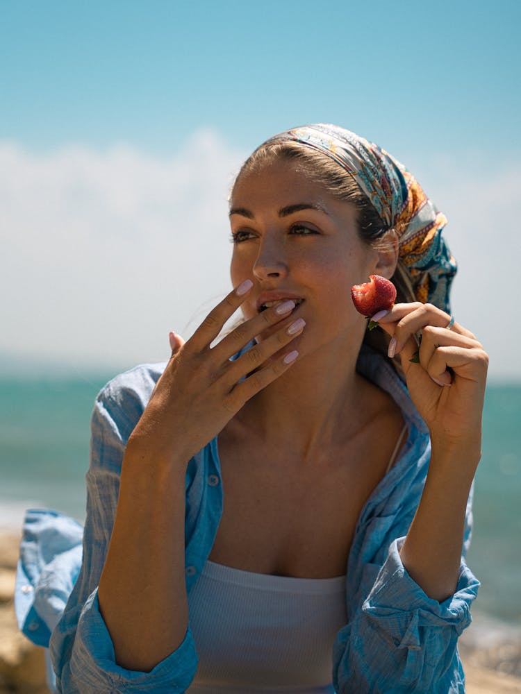 Woman In White Tube Top With Blue Shirt Eating Strawberry