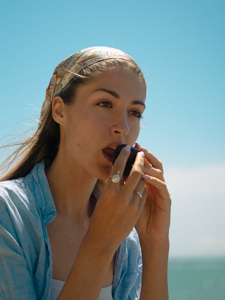 Beautiful Woman Eating A Fruit