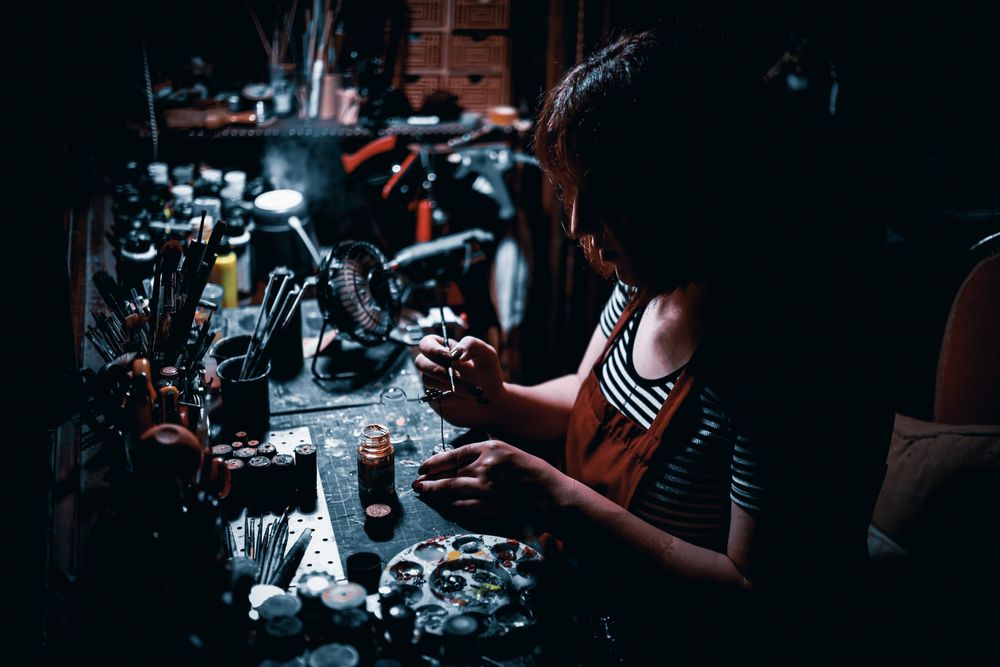 Maker at a dimly lit studio bench — photo by Emrah Yazıcıoğlu on Pexels