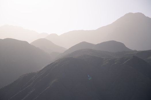 Beautiful silhouette of mountain range during sunrise, offering a calming nature view.