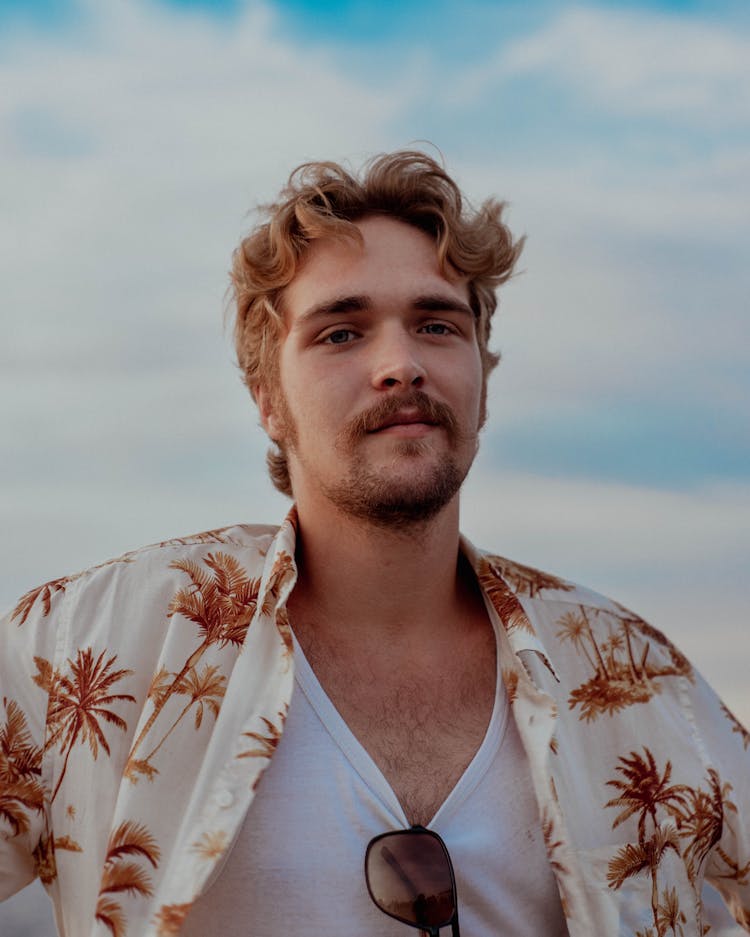 Portrait Of Young Man On Blue Sky Background