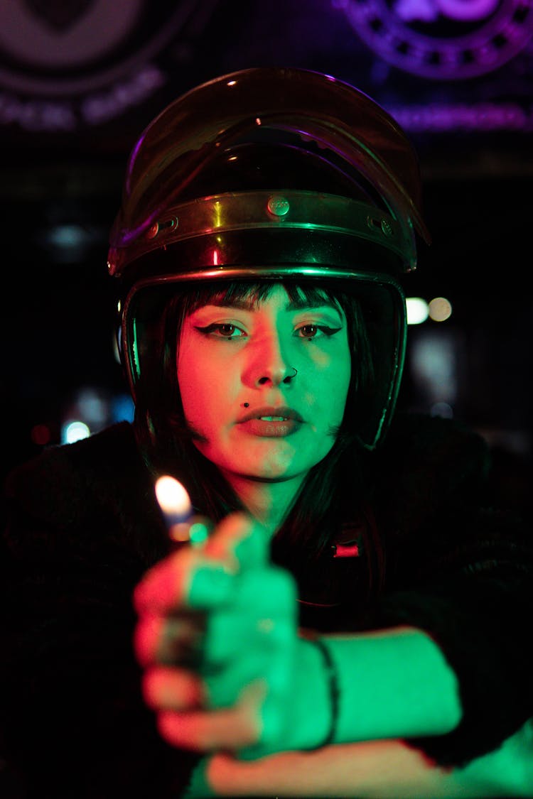 Woman In Helmet And Holding Lighter