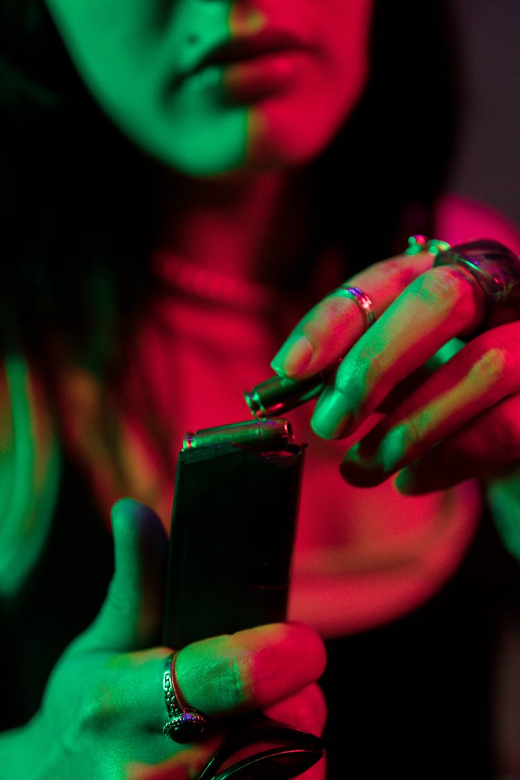 Woman Putting Bullet In A Cartridge