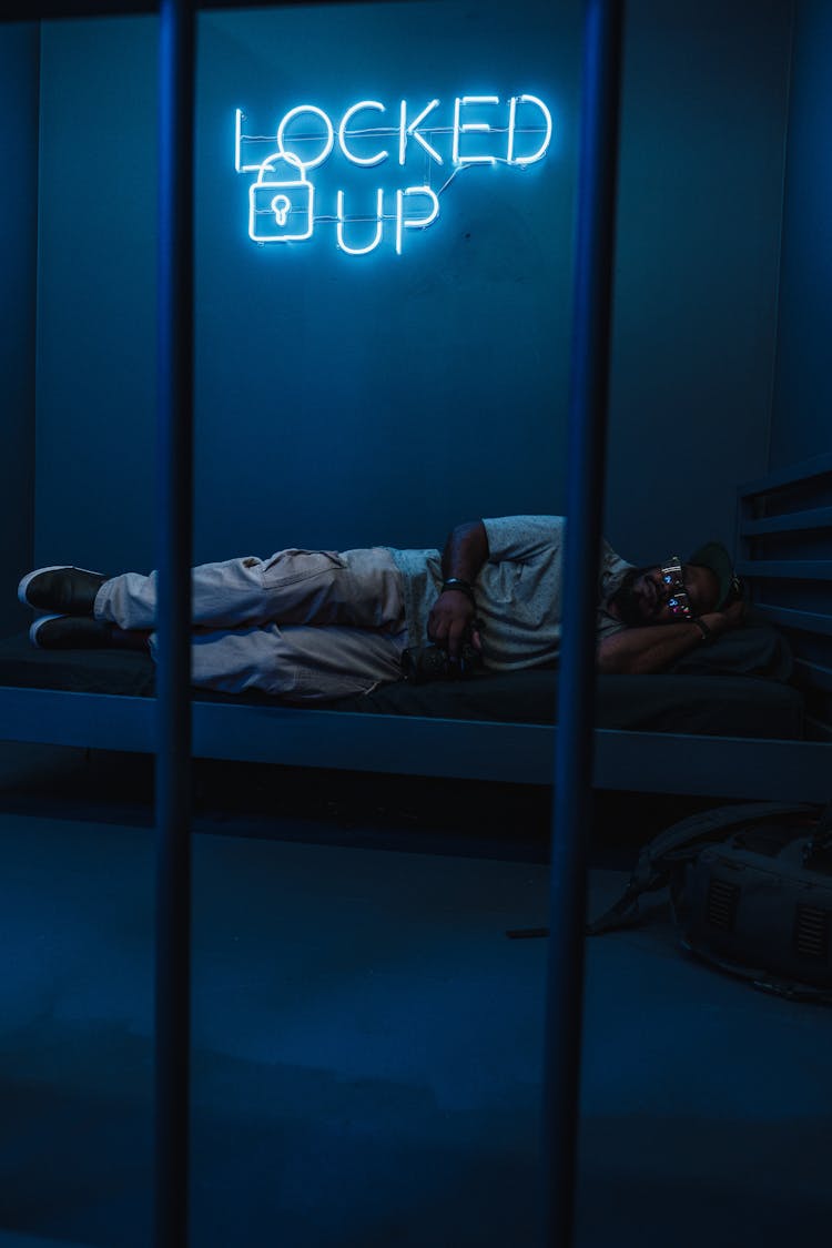 A Man Lying On Jail Bed 