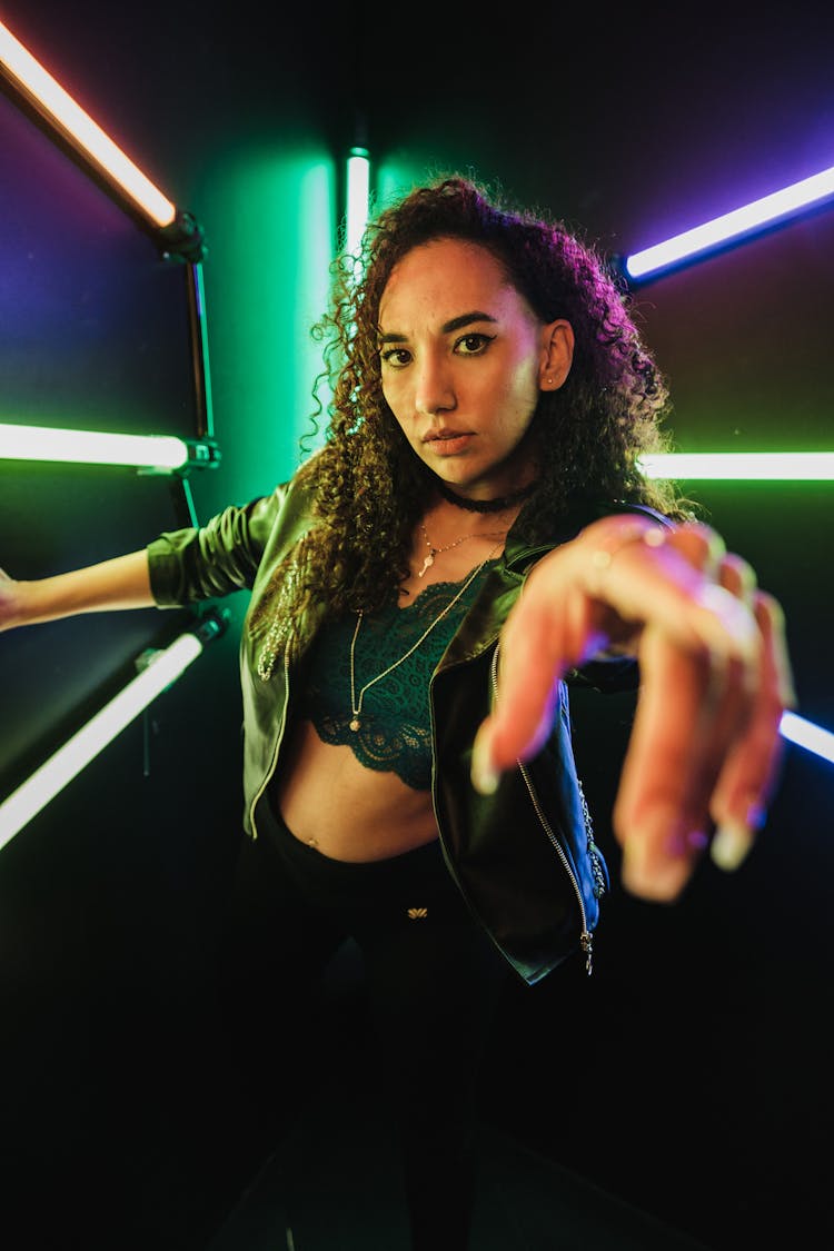 Woman Posing In Dark Studio With Neon Lights