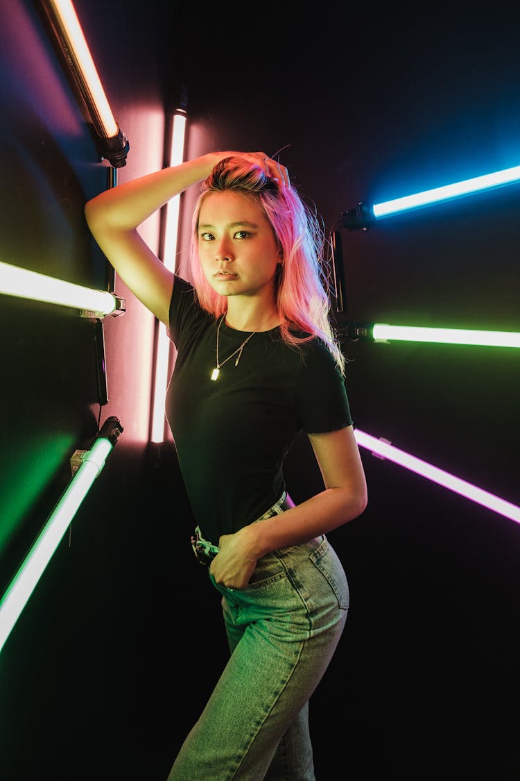 Girl Posing In Black Studio With Neon Lights