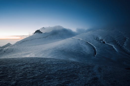A serene twilight view of snow-covered mountains in Zermatt, Switzerland, showcasing natural beauty.