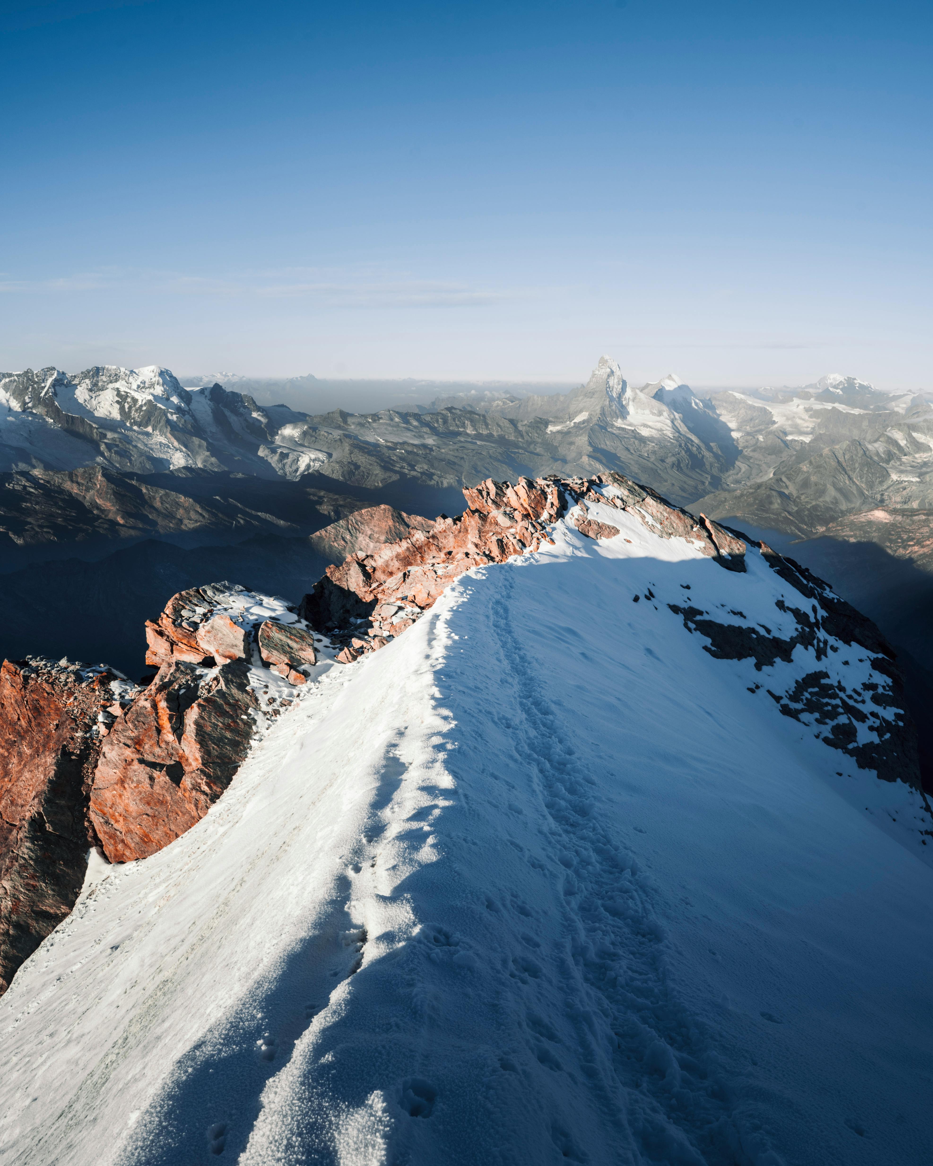 Prescription Goggle Inserts - A breathtaking view of a snow-covered mountain peak with clear blue sky, perfect for nature enthusiasts.