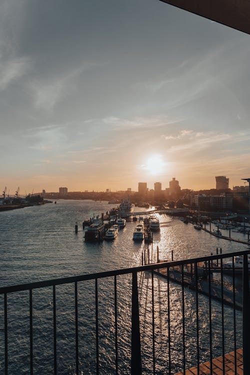 Ferries Docked on River seen from Balcony at Sunset