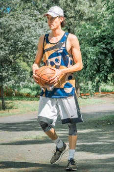 Active young man playing basketball outdoors in a park setting in Mexico City, showcasing an athletic lifestyle.