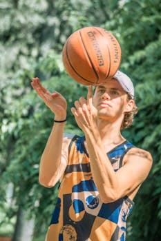 A young man playing basketball outdoors in Mexico City, exhibiting skill and focus in a vibrant setting.